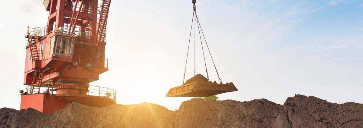 Industrial crane at sunset